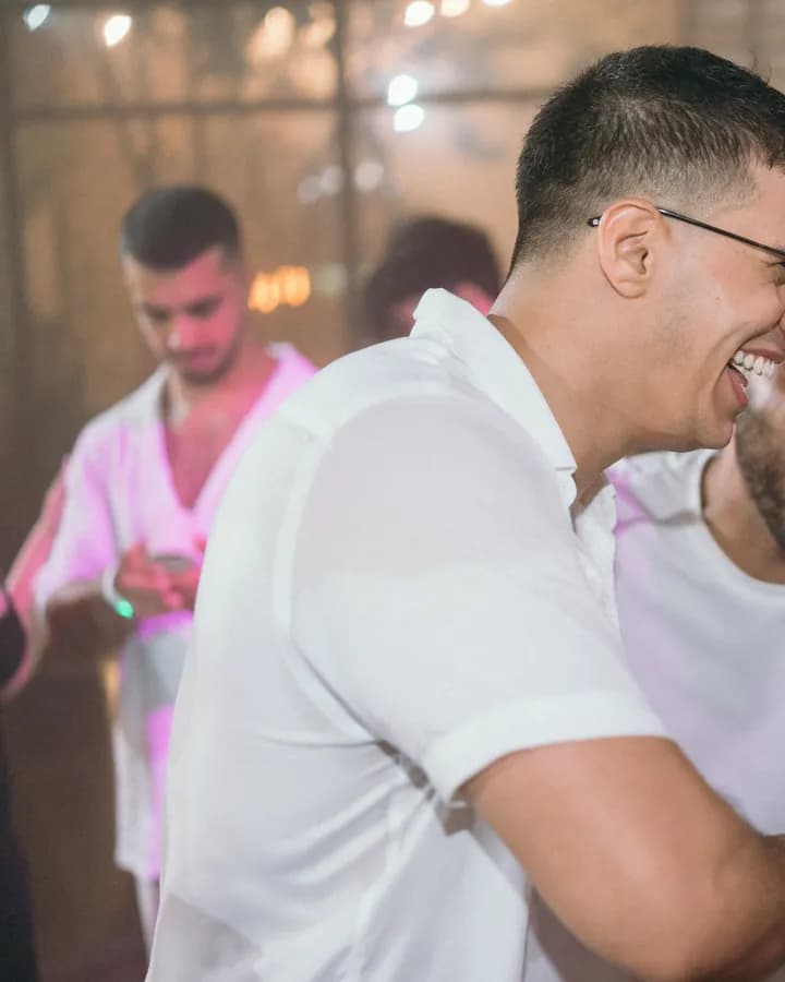 Two guests laughing together on the dance floor